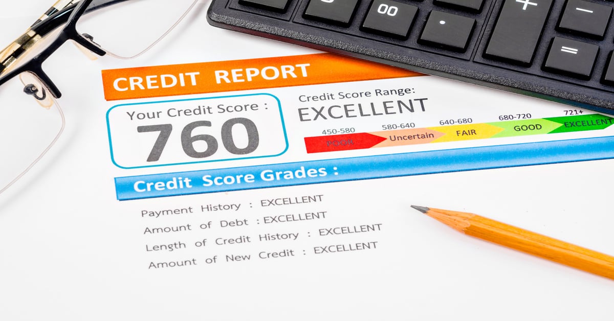 A close-up of a credit score report that reads "760" and "excellent" next to a pair of glasses and a black keyboard.